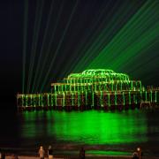 The West Pier lit up by lasers in 2010.