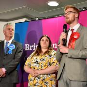 Defeated Conservative candidate in the Brighton Kemptown constituency Simon Kirby watches Lloyd Russell-Moyle of Labour make his victory speech.  Picture Simon Dack