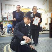 DOWN THE DRAIN: Police during an anti-street drinking campaign in Kemp Town in 2001
