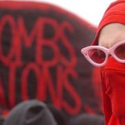 BAN THE BOMBS: A masked protester on Monday