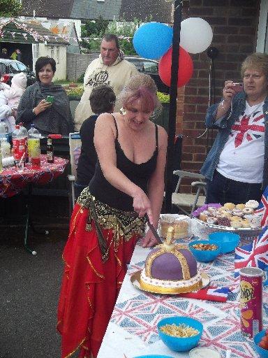Crowning glory as the cake is cut at the Diamond Jubilee street party in North Close, Portslade