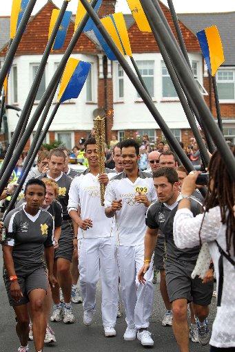 Thousands of people turned out in the early-morning sunshine in Brighton as the Olympic torch set off for its second day touring Sussex