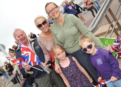 Thousands of people turned out in the early-morning sunshine in Brighton as the Olympic torch set off for its second day touring Sussex