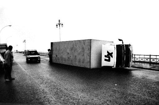 An articulated lorry or truck blown over on Brighton seafront