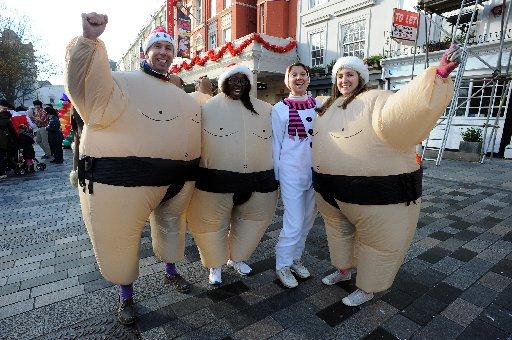 Charity fundraisers went running along New Road, Brighton taking Christmas puddings through an assault course