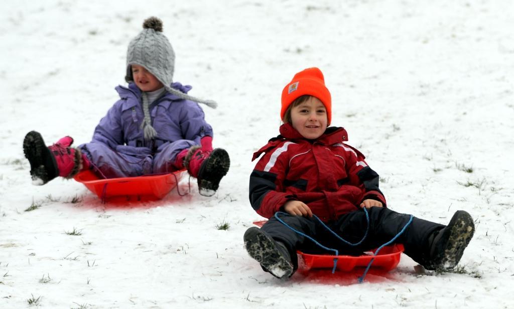 5-year-old Marta and 5 year old Alex sledging in Queens Park