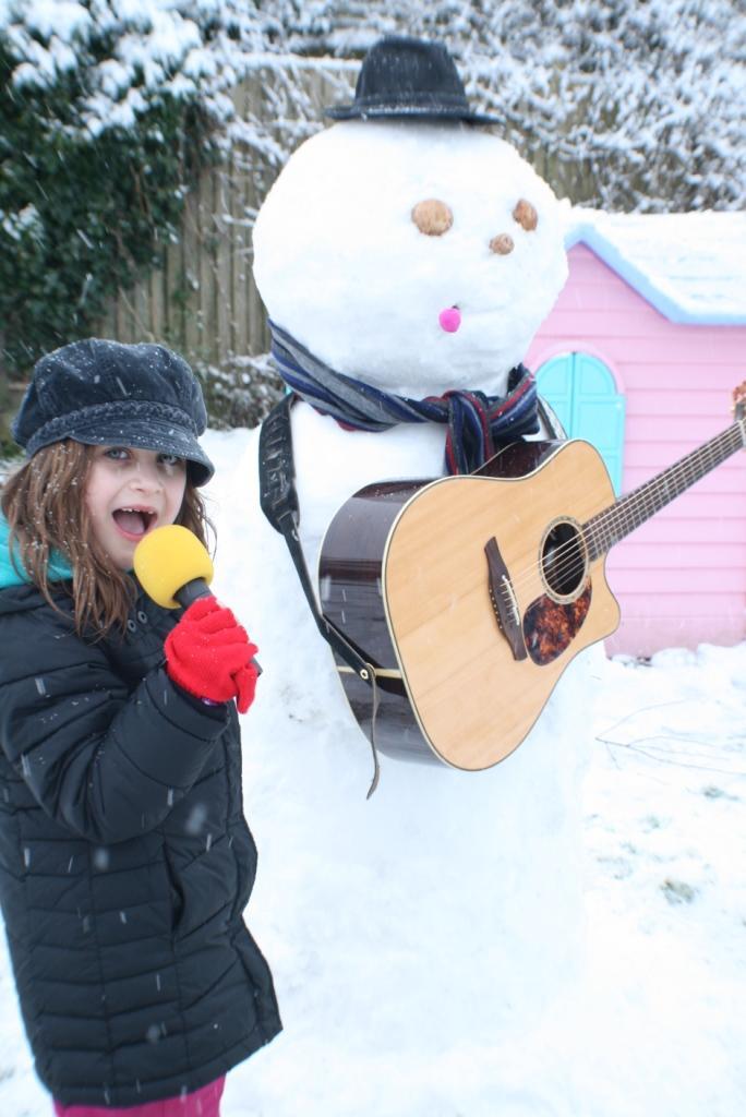 Rylee, 6, playing a live gig in Peacehaven with the snowman as lead guitar
