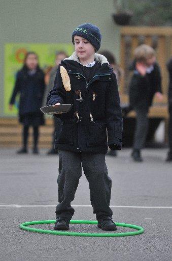 Schoolchildren at Elm Grove School in Worthing, raced around the playground carefully carrying pancakes