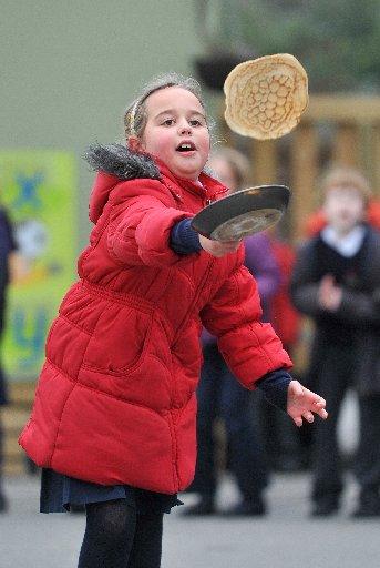 Schoolchildren at Elm Grove School in Worthing, raced around the playground carefully carrying pancakes