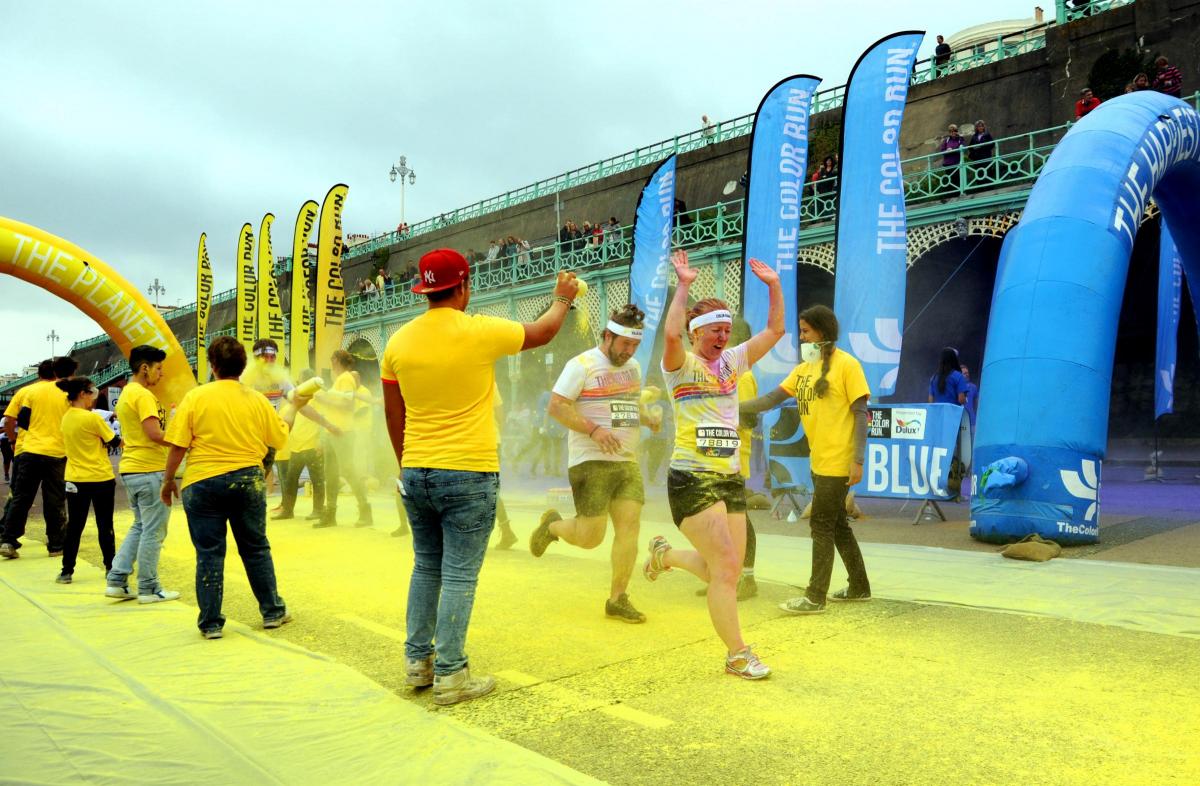 A KALEIDOSCOPE of colour marked the start of Brighton’s first Color Run on Saturday morning.
A cloud of rainbow paint marked the start of the race at 11am on Madeira Drive, as 6,000 entrants joined the lively party atmosphere dressed from head to toe i