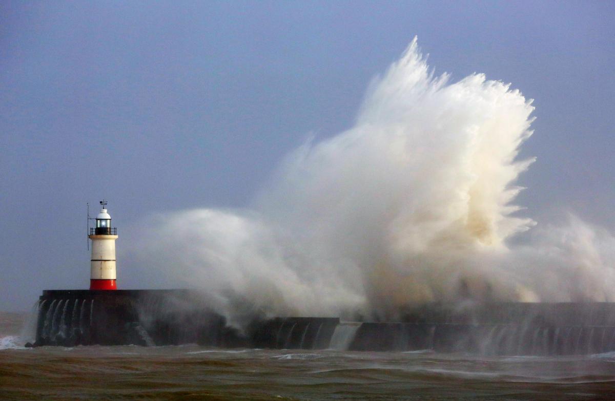 Waves crash over the harbour wall in Newhaven, Sussex, as large parts of Britain remain at risk of flooding as the country continues to be battered by strong winds and powerful waves. Gareth Fuller/PA Wire
