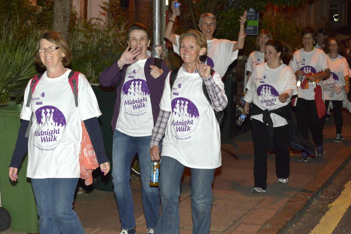 HUNDREDS of women enjoyed a girl’s night out with a difference as they walked 13 miles for charity – powering through a late-night storm.
The heavens opened as more than 600 determined walkers took on the Martlets Midnight Walk challenge on Friday ni