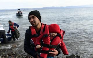 A migrant holds a baby on the Greek island of Lesbos, after crossing the Aegean sea from Turkey in February. An air strike by Syrian government forces had recently killed scores of Turkish soldiers in northeast Syria. AP Photo/Micheal Varakla