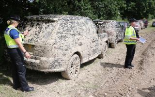 A file photo of a car parked in a muddy field in 2018