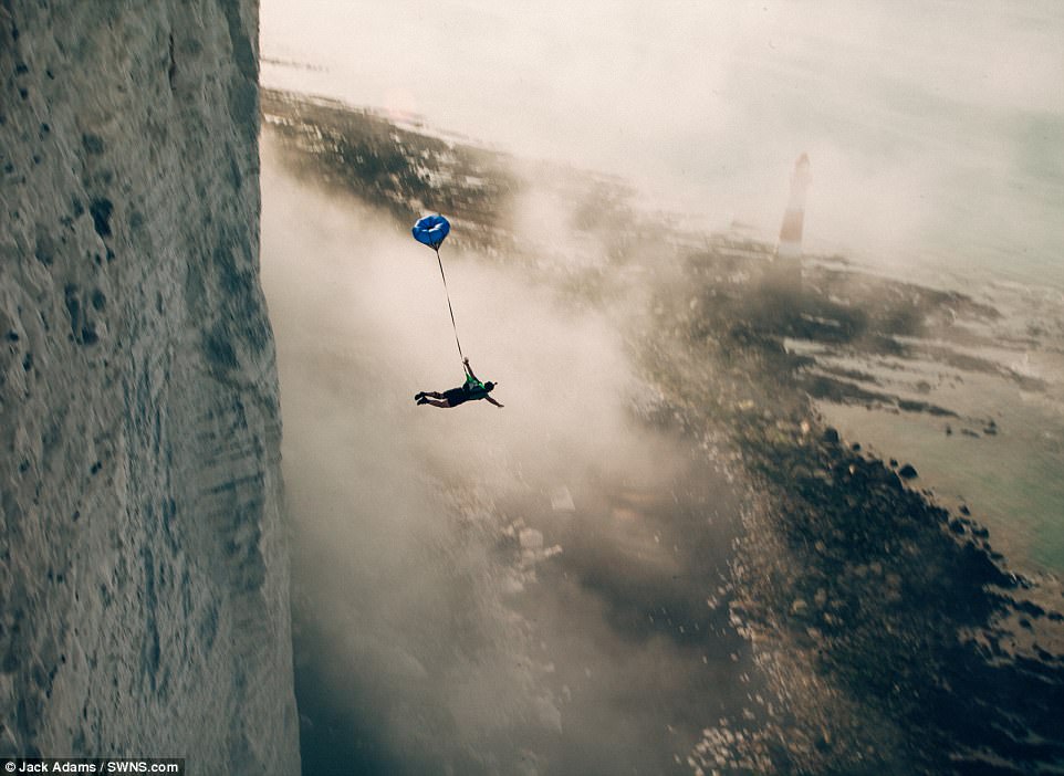 VIDEO: Adrenaline junkies leap from 530ft cliff edge at popular suicide spot
