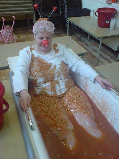 Debbie fro the St Martins church parent and toddler group at Lewes Road, Brighton in her sponsored 'Bath of Beans'