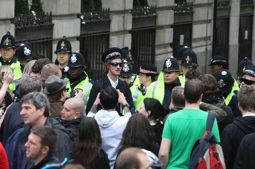 Police hold back the crowd outside the Bank of England
