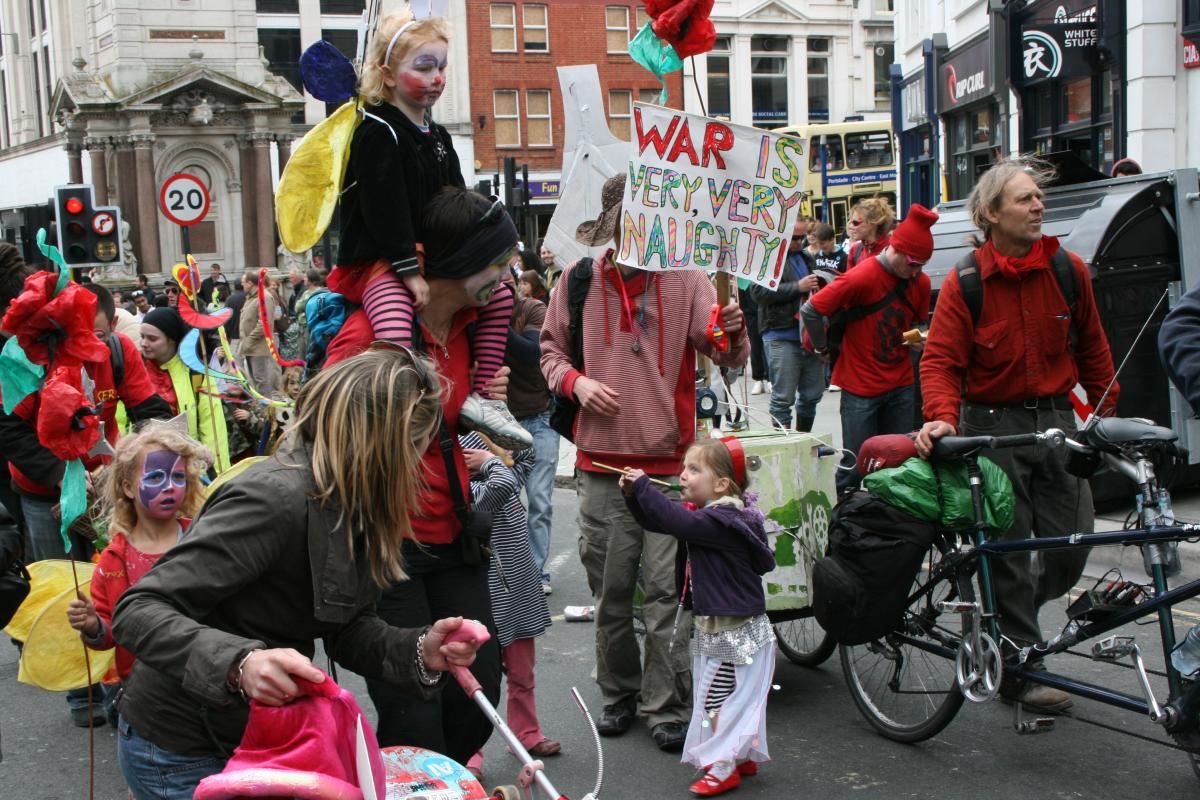 A banner proclaiming that war is "very, very naughty" while processing down North Street. Picture by Ben Collier.