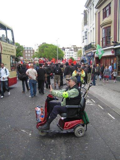 A protester on a mobility scooter joins the march.