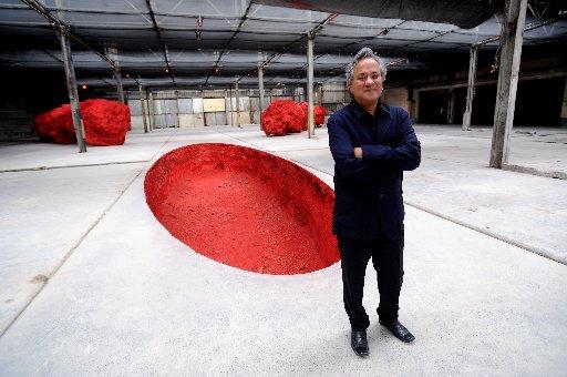 Anish Kapoor with his sculpture the Dismemberment of Jeanne D'Arc at the Old Municipal Market.