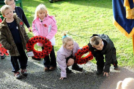 Children strain to catch a glimpse of Henry Allingham laying a wreath at Whitehawk Primary School during its Act of Remembrance on November 7 last year.