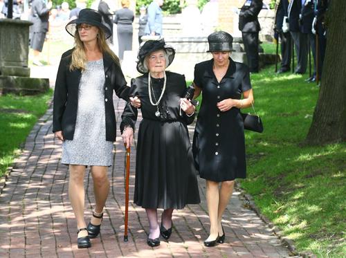 Estranged daughter Betty Hankin (centre) follows the coffin as it is carried into St. Nicholas' Church in Brighton