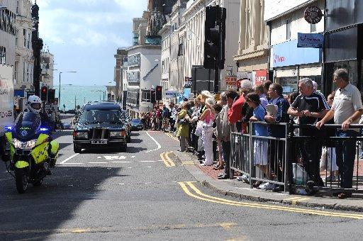 Crowds in West Street line up as the funeral cars go past.