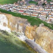 7 shocking drone images show extent of cliff fall metres from homes