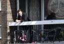 Matt Smith leaning over a balcony whilst filming in Brighton