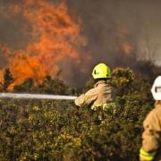 Firefighters tackle a wildfire in Ashdown Forest in 2019