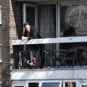 Matt Smith leaning over a balcony whilst filming in Brighton
