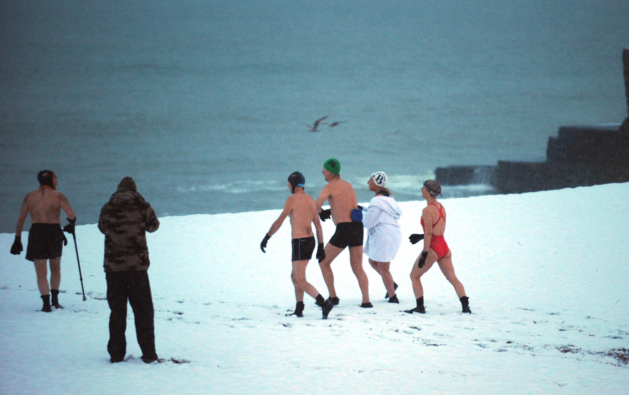 Brighton Swimming Club members out for their daily dip despite the weather after more snow fell this morning causing chaos in the city again.Photograph taken by Simon Dack 13 january 2010.