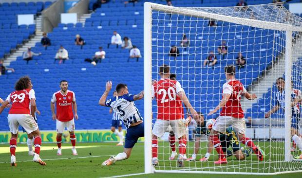 Lewis Dunk pokes home the equaliser against Arsenal during Albion's first game played behind closed doors due to coronavirus
