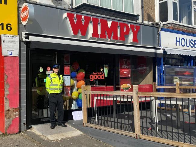A police officer stands outside the Wimpy in Portslade