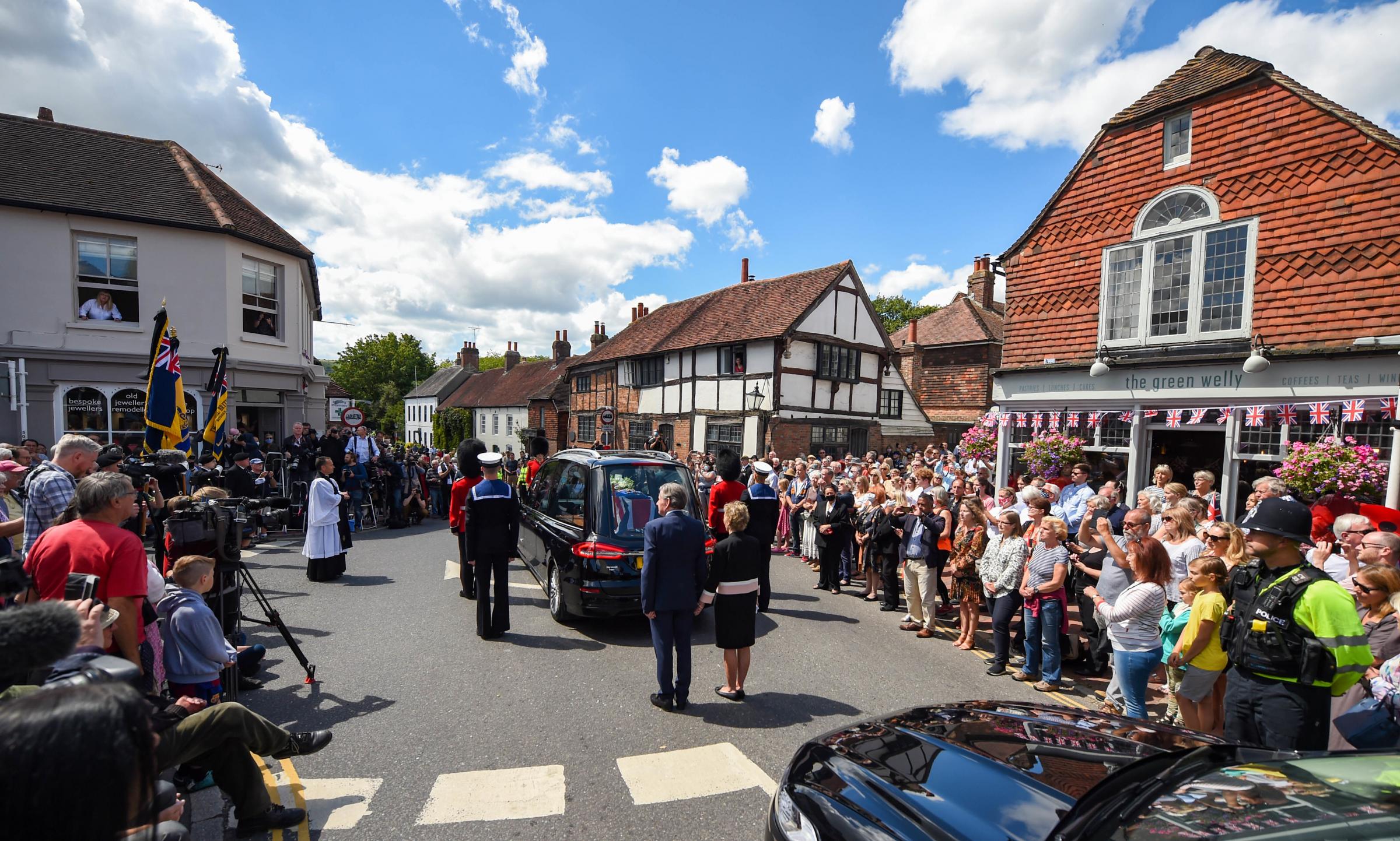 Ditchling Sussex UK 10th July 2020 - Residents and well-wishers line the streets of Ditchling as the funeral procession of Dame Vera Lynn passes by today . Singer Dame Vera Lynn who was known as the Forces Sweetheart died at the age of 103 on June 18th 