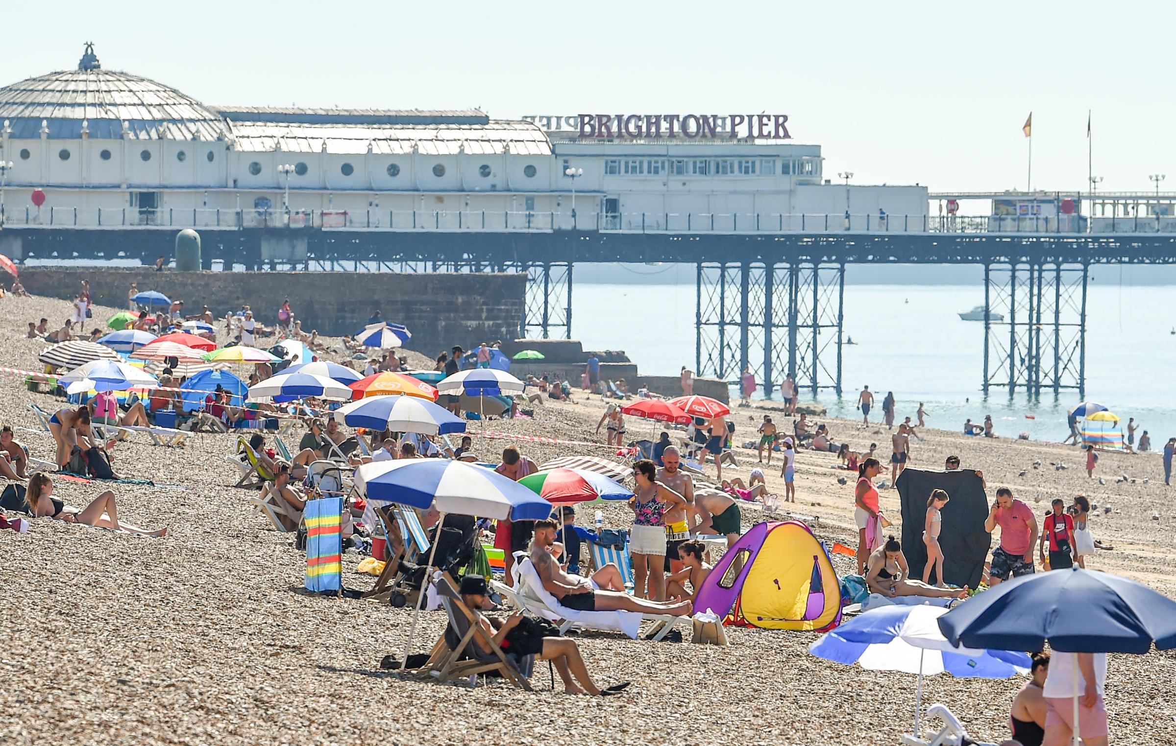Brighton UK 1st August 2020 - Brighton beach is already getting busy on a beautiful hot sunny day on what has been predicted to be the hottest day of the year so far with temperatures reaching the high 30 in some parts of the South East today : Credit