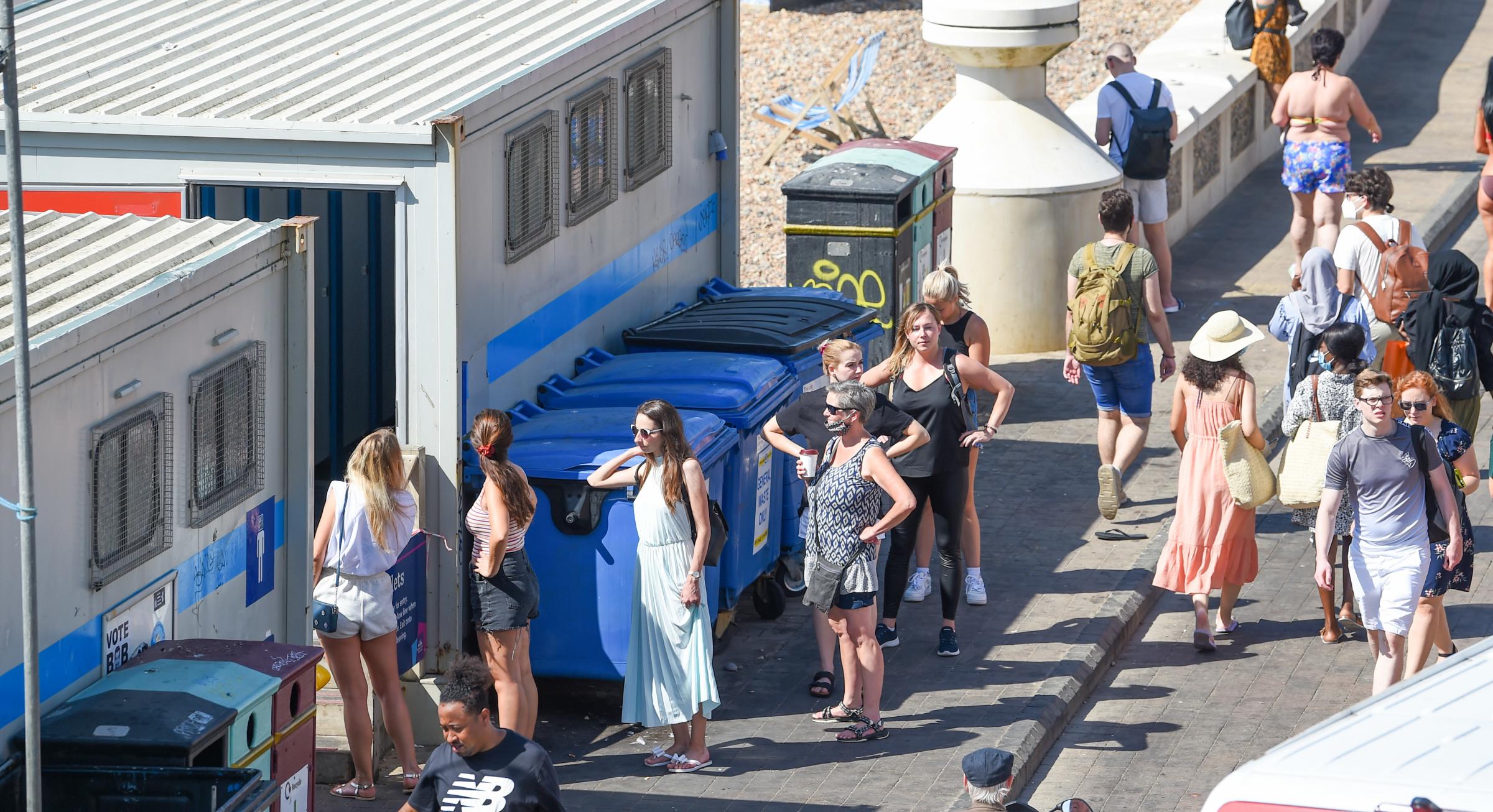 Brighton UK 1st August 2020 - A queue for the toilets on Brighton beach on what has been predicted to be the hottest day of the year so far with temperatures reaching the high 30 in some parts of the South East today : Credit Simon Dack / Alamy Live