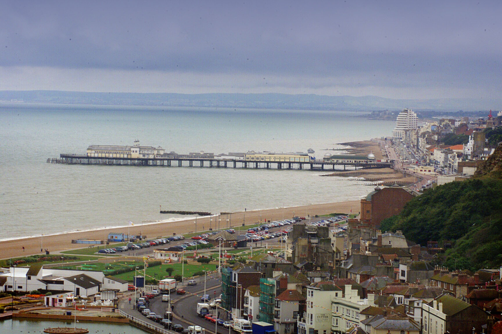 hastings seafront file pic taken from east hill cliff .hastings pier after restoration - hastings beach looking west to st leonards , bexhill and distance eastbourne (left of pic).