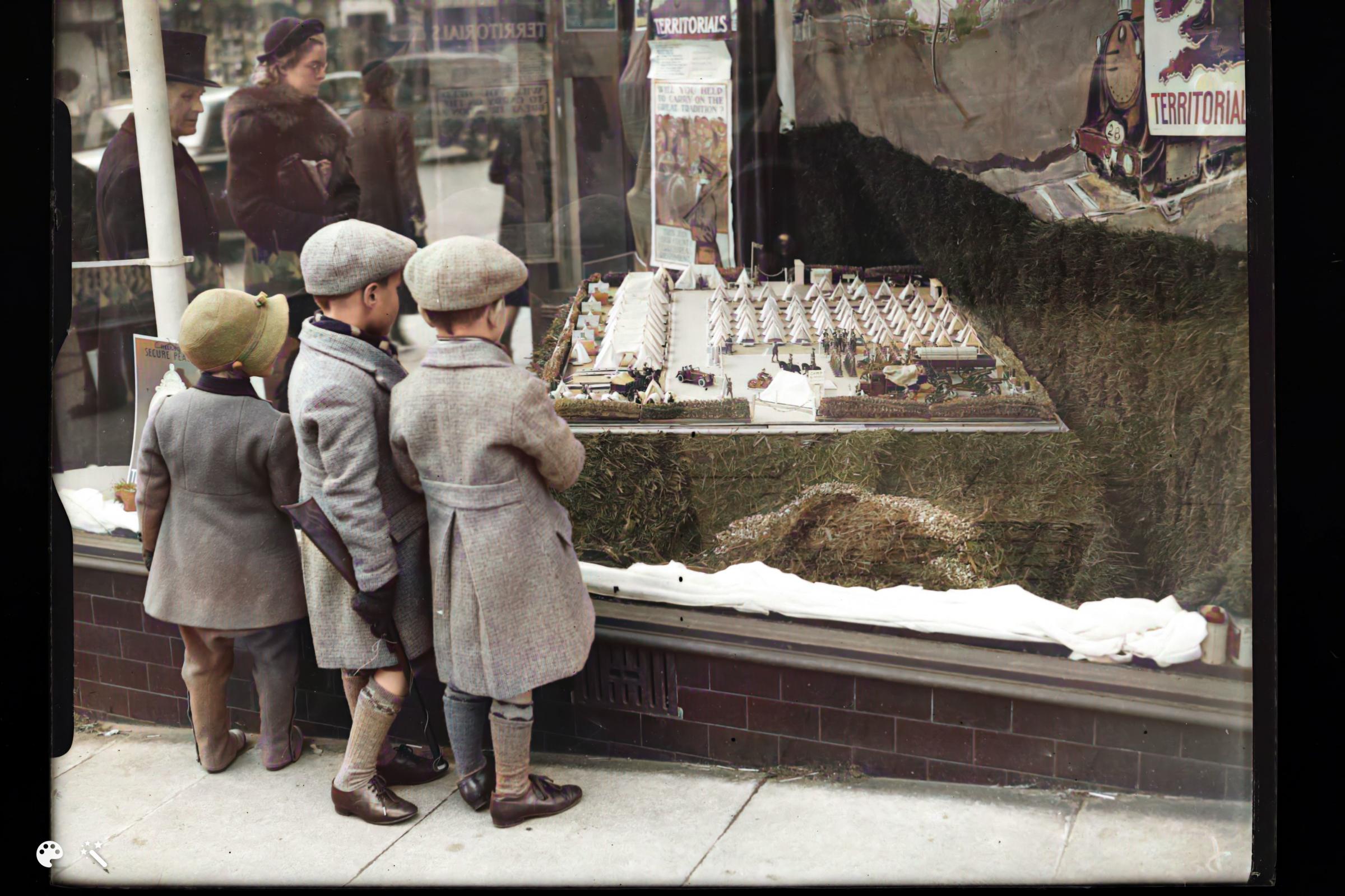 Children studying some sort of military scene in a shop window in the late 1930s. Was this pre-war propaganda?