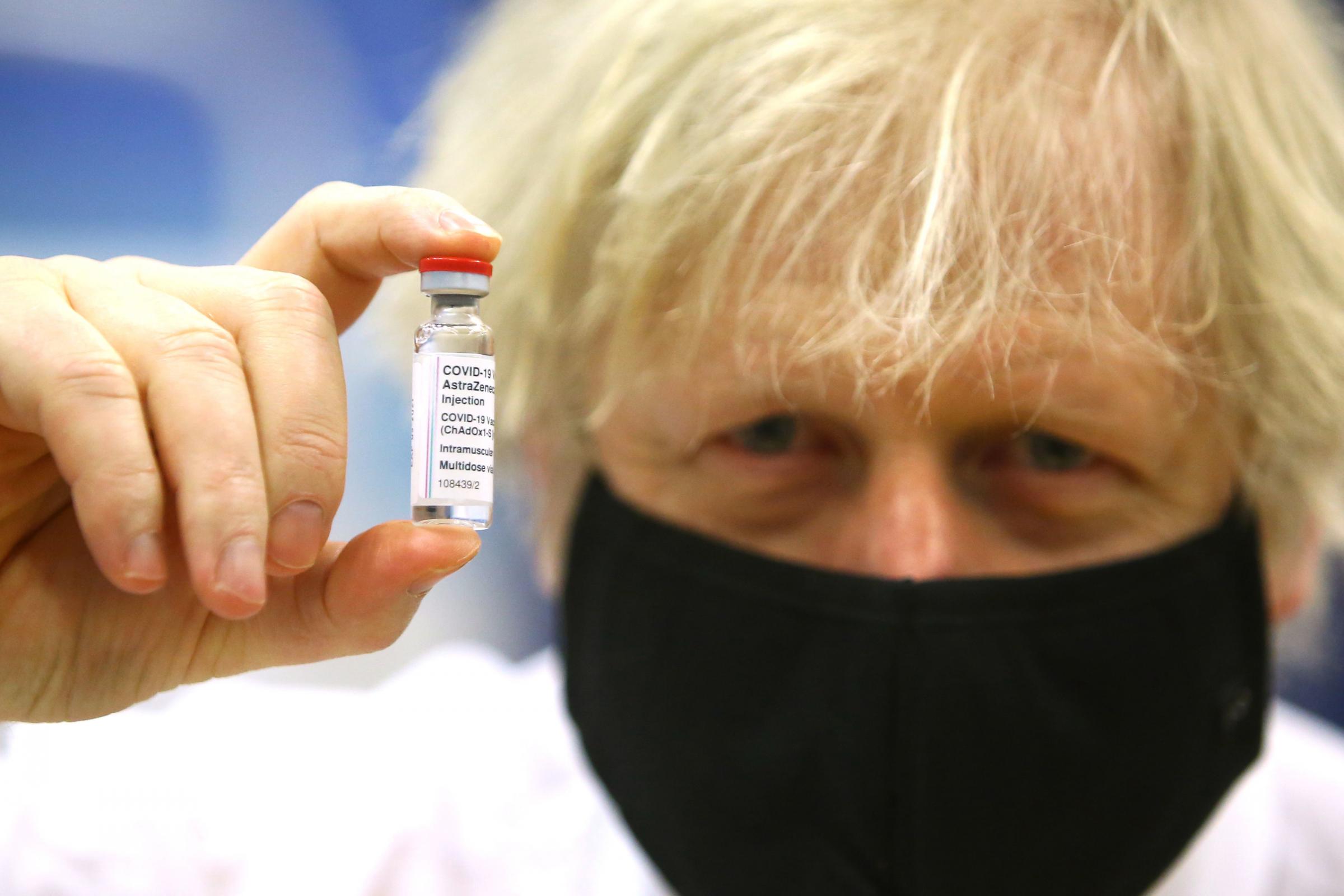 Prime minister Boris Johnson holding a vial of the Oxford/Astra Zeneca Covid-19 vaccine as he visits a vaccination centre at Cwmbran Stadium in Cwmbran, south Wales. Picture date: Wednesday February 17, 2021. PA Photo. See PA story HEALTH Coronavirus. Pho