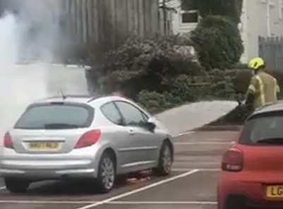 Firefighters worked quickly to extinguish a car fire in the car park of the Tesco superstore in Hove Credit: Chris Simmons eight-year-old daughter Anna