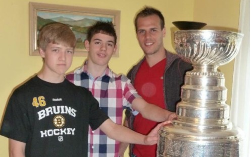 Danny Terry, 25, centre, pictured with his pal Charlie, left, and Czech ice hockey pro David Krejci and celebrated Boston Bruins victory in the Stanley Cup