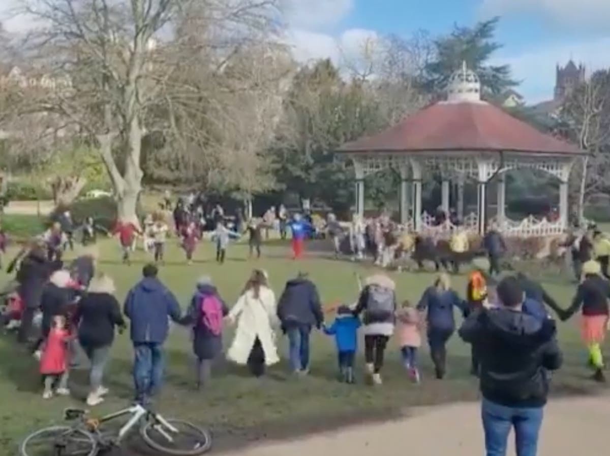 Group performs the Hokey Cokey in a Hastings park