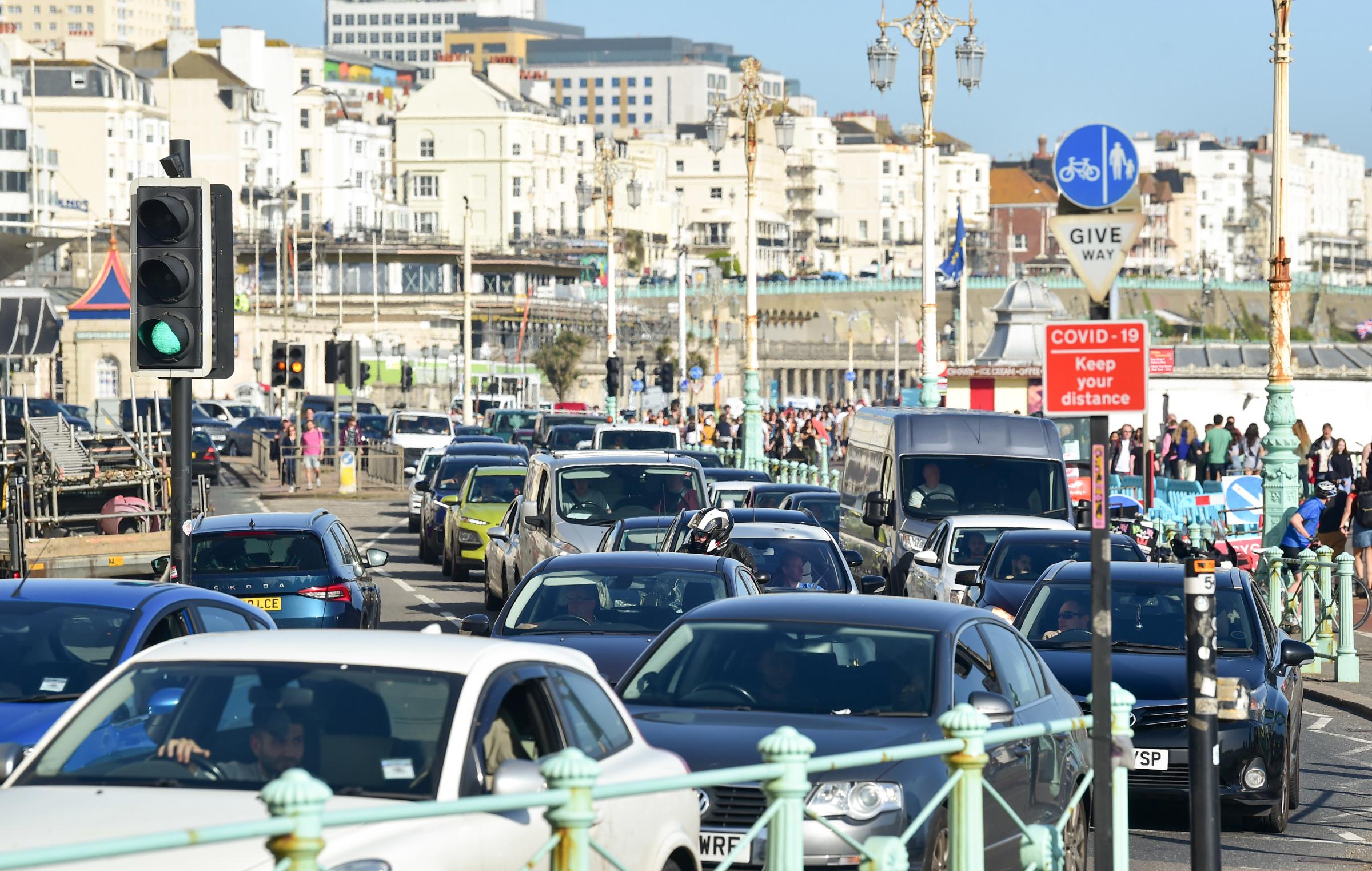 Brighton UK 30th March 2021 - The traffic congestion on Brighton seafront as visitors flock to the seaside on the hottest day of the year so far with temperatures reaching the mid 20s centigrade in parts of the South East : Credit Simon Dack / Alamy