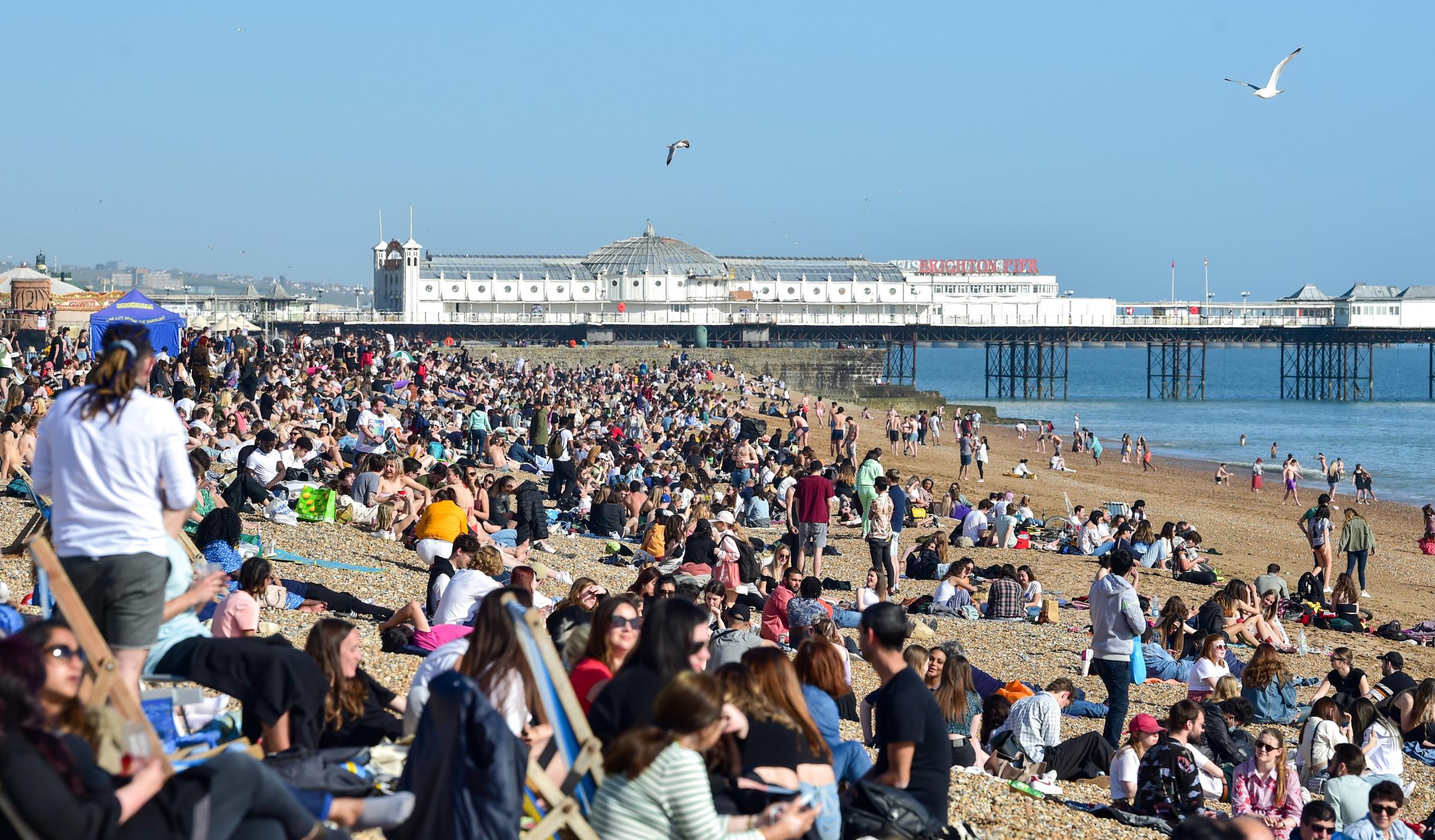 Brighton UK 30th March 2021 - Brighton beach is packed as visitors flock to the seaside on the hottest day of the year so far with temperatures reaching the mid 20s centigrade in parts of the South East : Credit Simon Dack / Alamy Live News.........