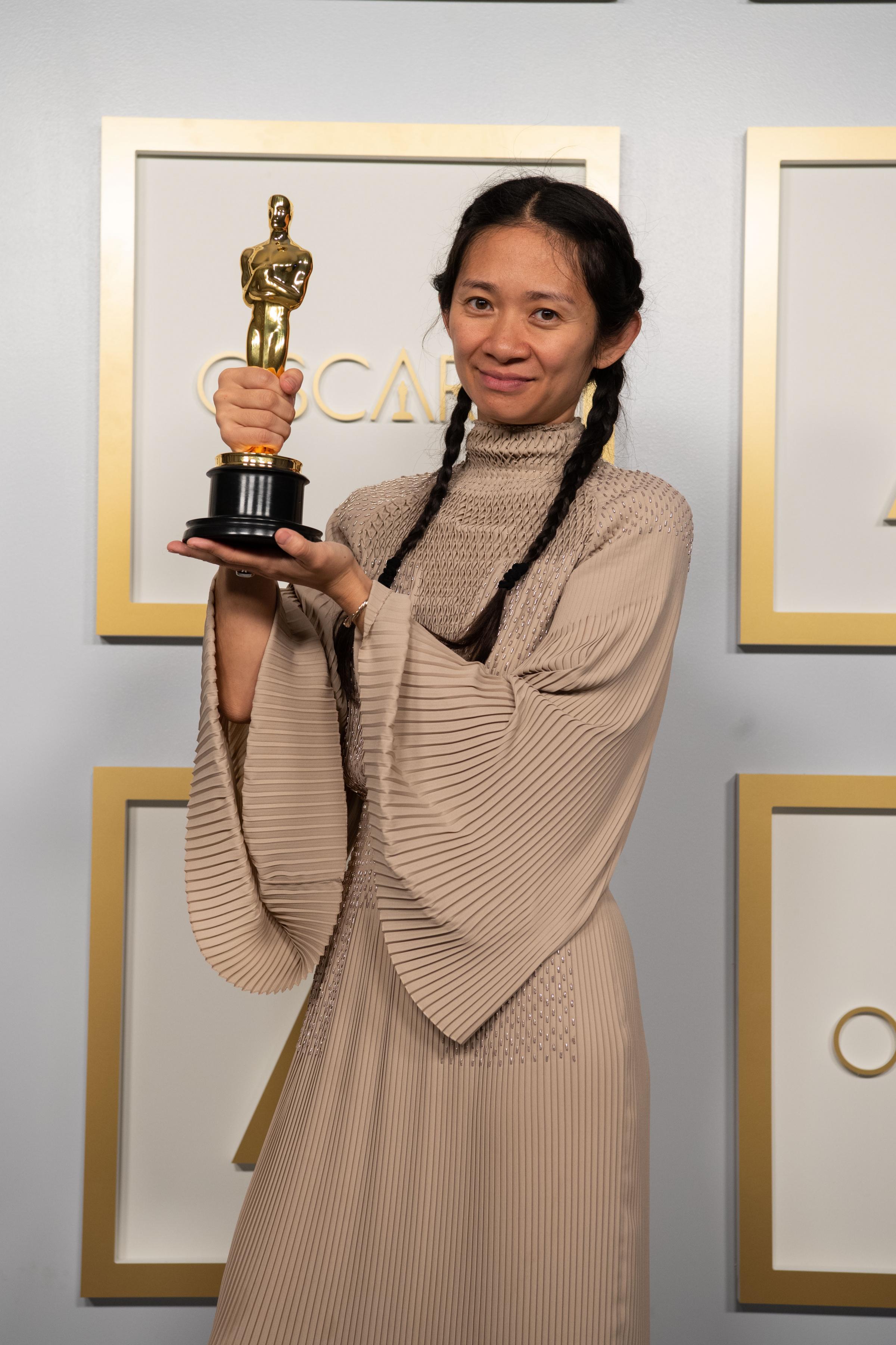 Chloe Zhao posing backstage with the Oscar for Directing, for the film Nomadland, at the 93rd Academy Awards ceremony held at Union Station in Los Angeles, California