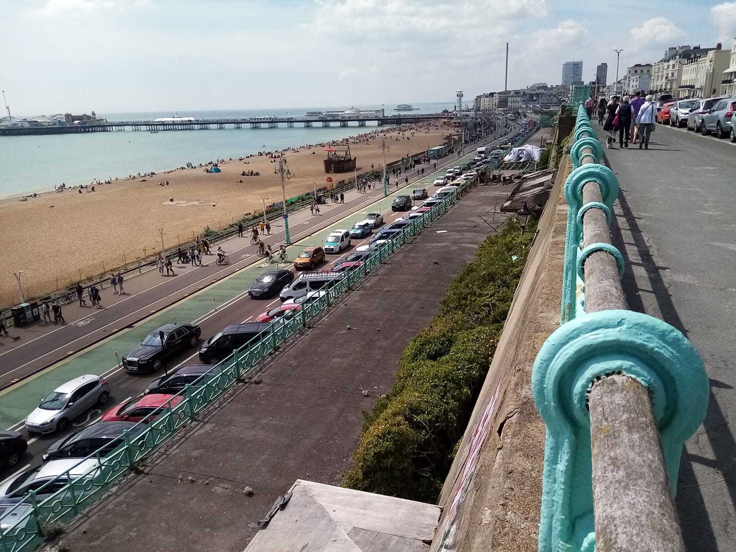The queue of cars along Madeira Drive - a tent on the crumbling, Grade-II listed Madeira Terrace is also pictured 