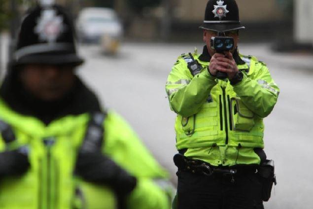 Police officer with speeding camera