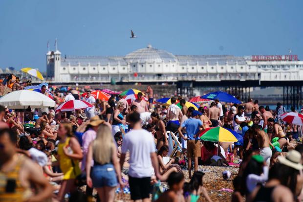People enjoy the hot weather on Brighton beach