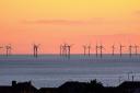Rampion wind farm silhouetted against an orange sky. Picture by: Dave Mason, from Brighton..